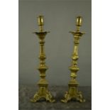 A pair of brass candlesticks, with knopped stems, and shaped drip pan, 41 cm high.