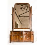 A William & Mary walnut toilet mirror, with stepped and shaped drawers, and small knop handles.