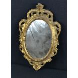 A small giltwood oval wall mirror, 30 by 19cm.