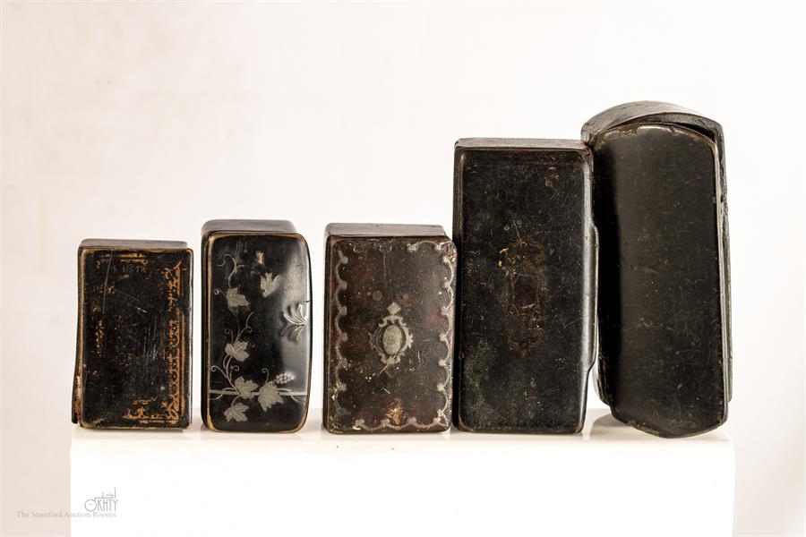 A group of five 19th century papier mache snuff boxes.