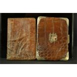 Two crocodile skin wallets, one with silver monogram and corner mounts.