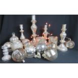 A large group of silvered glass candlesticks, holders and baubles.