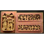 Three Chinese red lacquered and gilded carved panels, one 29 by 20cm high.