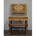 An oak 18th century tapestry chair with velvet back and seat bearing shield to the back, raised on