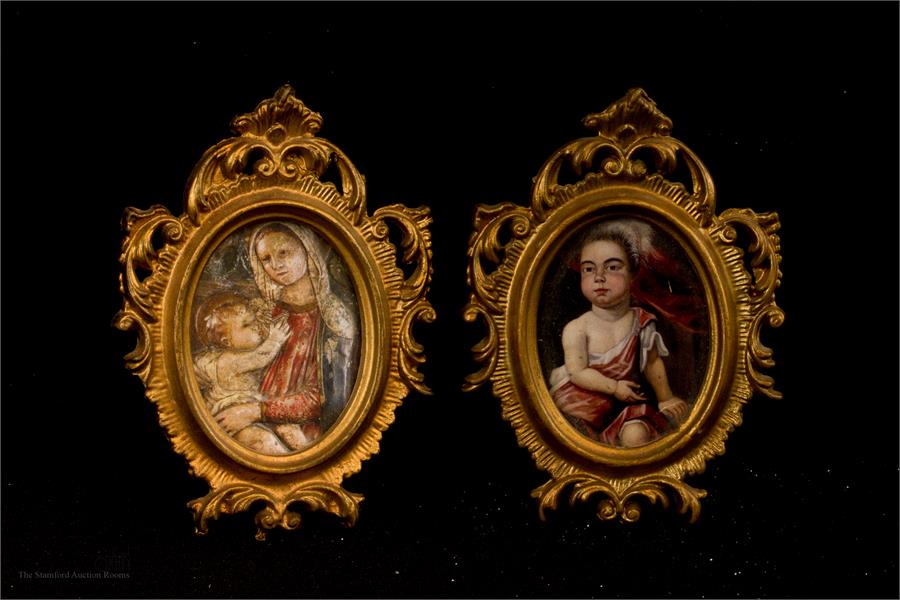 Two miniature frames containing prints.