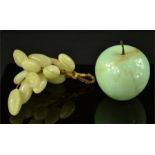 A group of agate grapes and an apple.