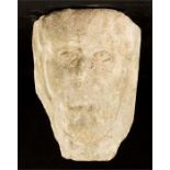 An early stone carved corbel head, 24cm high, 25cm long.