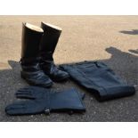 A pair of Vintage motorcycle boots, trousers and gloves.