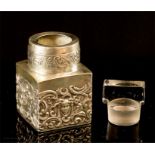 A silver perfume bottle, with original glass stopper, embossed with face masks and initialled to the