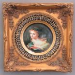 A porcelain cabinet plate mounted into a gilt frame, decorated with a fairy.