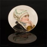 A hand painted porcelain dish depicting profile portrait of a woman.