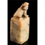 A small carved Chinese soap stone seal with dog of fo surmount, 5½cm high.