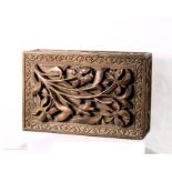 A treen box carved in relief to depict irises to the lid.