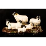 A group of Beswick figures, including Ram and Sheep Dog, together with a tree stump display stand.