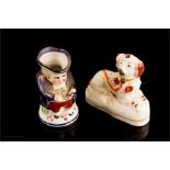 A miniature 19th century Staffordshire toby jug, 7cm high, and a miniature 19th century