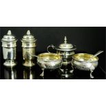 A group of silver to include a pair of salts together with the original spoons, a lidded salt, and a