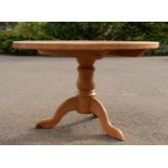 A bespoke made pine kitchen table, with circular top, and tripod base, 75cm high, 120cm wide, 5cm