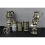 A group of early pewter, to include tankards, jug and a measure etc.