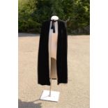 A black velvet evening cape, with hood and satin lining.