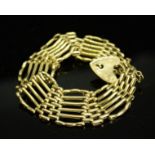 A 9ct gold gate bracelet, with heart form clasp and safety chain, 21.9g.
