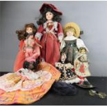 A group of porcelain faced dolls.