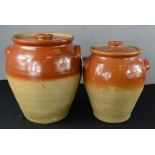 Two terracotta pippins with covers.