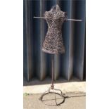 A metal and wicker dress dummy.