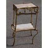 A French ormolu and marble two tier table, adorned with gilt metal swags and face masks, 83 by 52 by