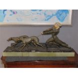 Menneville, circa 1930, an Art Deco spelter and ivorine group; Rochard; lady and dogs, raised on a