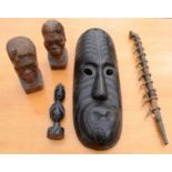 A group of African carvings including mask, male and female heads, pipe etc.