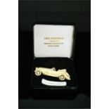 A 9ct gold brooch in the form of a motor car, 4.1g.