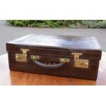 An early 20th century leather 'crocodile skin' style case, with cloth interior, and outer slip,