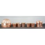 A group of copper to include an early set of toddy cups, jelly mould etc.