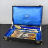 A silver plated and horn handled canteen in oak box, blue silk lined.