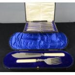 A set of six silver plated butter knives, and a fish slice and fork set, both in original boxes.