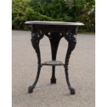 A cast iron table with circular top, the legs cast with Britannia figures.