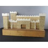 A model castle, painted with decoration.