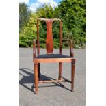 A mahogany armchair with black velvet seat.