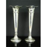 A pair of silver Asprey bud vases, with wavy top, weighted bases.