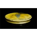 A 19th century horn snuff box, oval form, inset with a shield to the lid, 85 by 45cm.