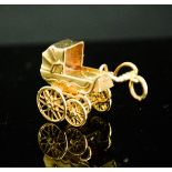 A 9ct gold pram pendant, 10.24g.