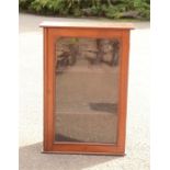 A glass display cabinet with two shelves and key.