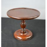 A Georgian mahogany cheese coaster, on gun barrel column, with tray circular top, 20cm high, 25cm