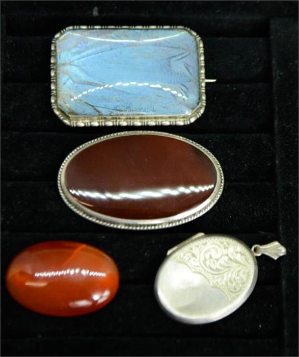 A group of silver to include a silver locket, silver and agate brooch, agate brooch and a silver