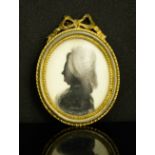 A 19th century French silhouette, profile portrait of a woman, in gilt metal frame.