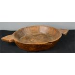 A treen shallow bowl with shaped integral handles.