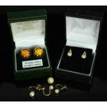 A pair of 9ct gold and pearl earrings, a pair of 9ct gold stud earrings, and a pair of amber and