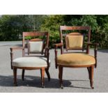 Two Edwardian mahogany inlaid salon chairs, with bowed arms.