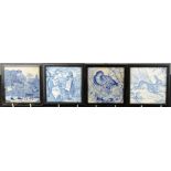 A group of four blue and white Delft tiles, two depicting children, a grouse and the other a hare.