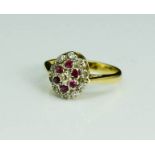 An 18ct gold, diamond and ruby cluster ring, 4.03g.